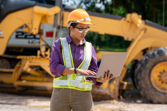 Engineer women use laptop computer on construction site