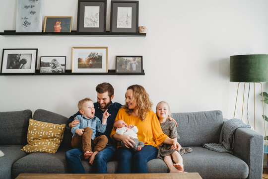 Happy white family on couch in their living room at home