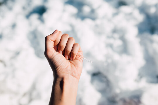 Female hand holding a large icicle