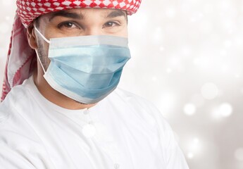 Smiling Saudi arab young man wearing a mask