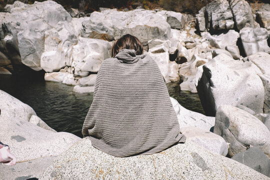 Figure Cloaked in a towel Looks like the surrounding Rock.