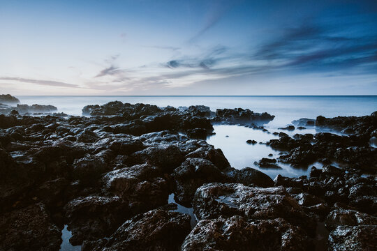 Lava rock coastline in Hawaii at dusk