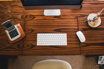 shot of table computer with mouse and keyboard on wooden table