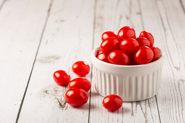 Naklejka na ściany i meble Fresh grape tomatoes in a bowl on the table.