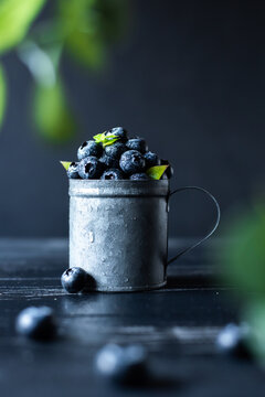 closeup blueberries in vintage metalic cup