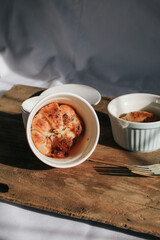 Ham Cheese Croissant with Bacon on wooden board under morning sunlight, horizontal composition. Comfort food concept