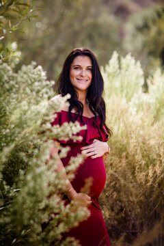 Expectant Mother Standing in Field Smiling for Camera in San Diego