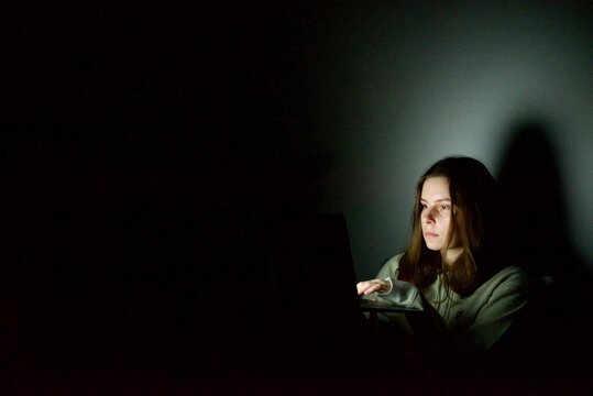 woman working on laptop at night