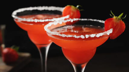 Fresh homemade refreshing strawberry cocktail margarita in glasses on the table