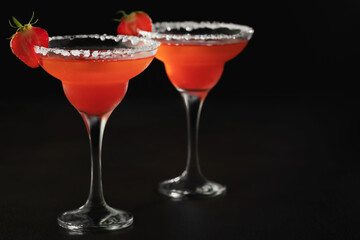 Fresh homemade refreshing strawberry cocktail margarita in glasses on the table with copy space