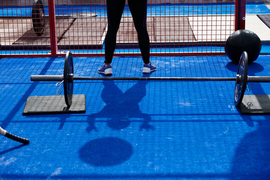 Shadow of female exercising with medicine ball