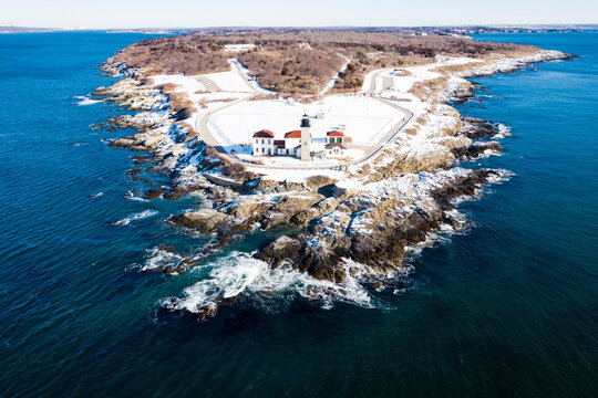 Beavertail Lighthouse of Rhode Island in winter snow by aerial drone