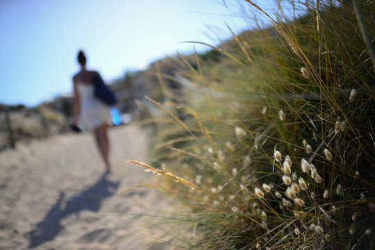 Young caucasian woman walking on the beach