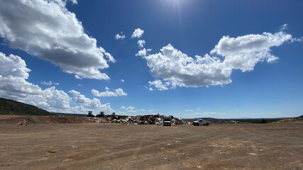 Large clouds shift above landfill