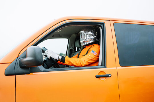Man dressed as astronaut driving the van