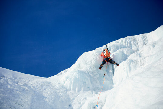 Male Ice climbing guide leading an ice climb in New Hampshire
