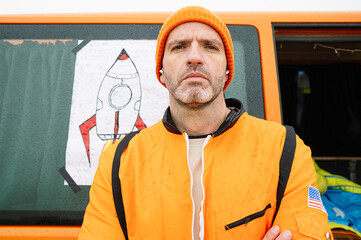 Man dressed as an astronaut looking at camera