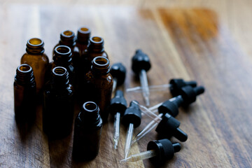 flat lay of empty glass amber dropper bottles