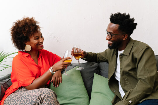 woman, African American, Black, portrait, social, afro, hair, black, smile, people, party, beauty, home, home party, plant, glass, wine, adult, millennial, smiling, person, orange, face, fashion, fun,