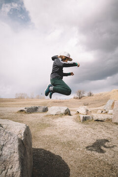 Boy Caught MidAir as he leaps from Boulder