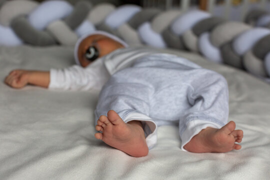 Newborn baby sleeps, legs close-up