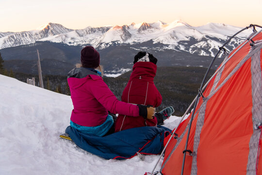 Woman camping with dog during vacation