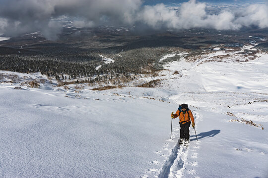 Man splitboarding on snowcapped mountain