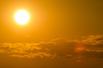 Yellow sun and many clouds below. Space for text.
