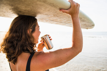 Woman Enjoying Morning Coffee before Surf