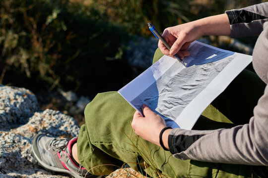 Close-up of a woman explorer and geographer analyzes the environment