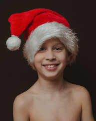 Fototapeta premium portrait of a happy boy in a red Christmas gnome hat