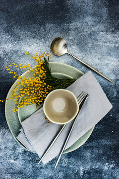 Spring mimosa flowers and table setting