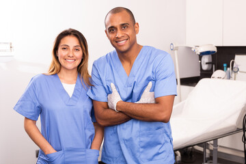 Obraz premium Portrait of qualified female and male cosmetologists smiling confidently in medical center