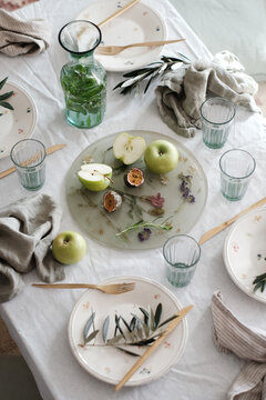 Spring light table setting with white tablecloth for family gathering