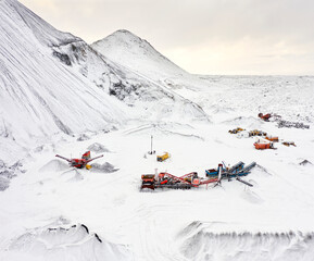 Heavy machinery for construction on snowy hill