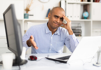 Fototapeta premium Tired businessman working with documents in office at the table