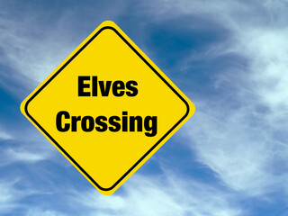 Yellow diamond shaped road warning sign with a Christmas theme concept. Elves Crossing text.