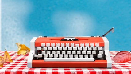 Old typewriter on a table with autumn leaves
