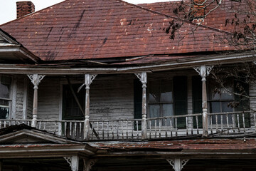 Abandoned dilapidated creepy wooden house second story porch