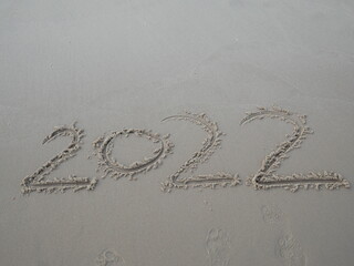 written word 2022 on the sand beach,New year concept.
