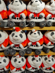 cute and funny panda in Santa Claus clothes Cute and funny kids toys on shelf in store