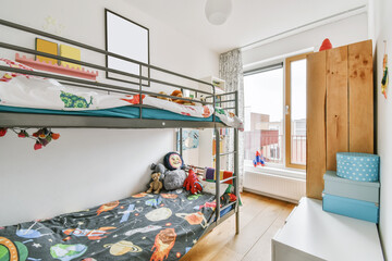 Stylish children's room with a bunk bed and paintings on the wall