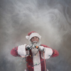 Santa Claus plugging in Christmas lights looking shocked surrounded by smoke