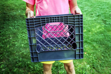 Teen boy holding a milk crate for the social media milk crate challenge