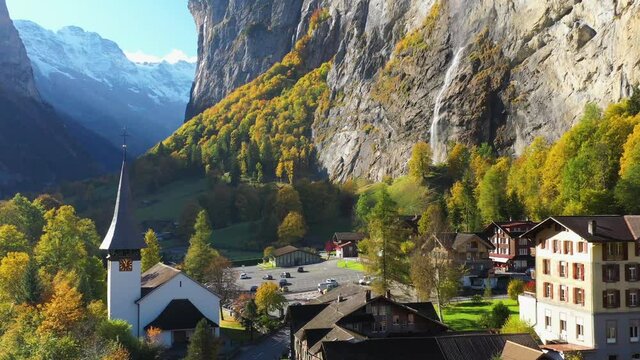 Revealing drone shot of the Staubbach waterfall church in Lauterbrunnen Bernese Oberland Switzerland