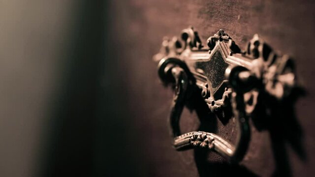 Light revealing vintage handle on wooden treasure chest. Close up cinematic