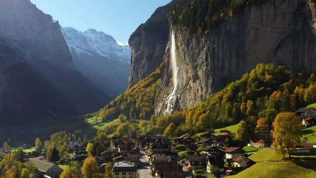 Revealing drone shot of Lauterbrunnen, Switzerland and Staubbach Waterfall