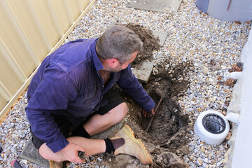 Plumber fixing an underground water pipe leaking