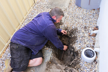 Plumber fixing an underground water pipe leaking
