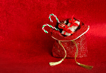 Filled Christmas bag on red glitter background